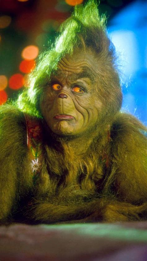 The Grinch (Jim Carrey) is a grouchy green monster who lives high up on a mountain …